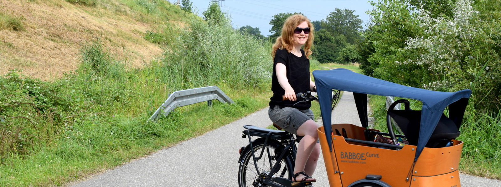 Lastenfahrrad Babboe Curve-E Elektro Bike Fahrrad fahren mit Baby, Kleinkind und Kind für die Fahrradtour mit Kindertransport vorne.